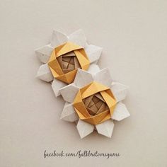 an origami flower made out of folded paper