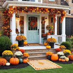 a front porch decorated for fall with pumpkins and flowers