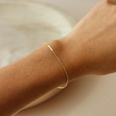 Our Sailor Bracelet is one of our fan favorites! As a best selling chain, the Sailor Bracelet is known for its perfectly dainty bar and link chain. The understated elegance of this bracelet leaves your stacking options endless! DETAILS 14k Gold Fill or Sterling SilverBracelet Sizing: XS=5.5", S=6", M=6.5", L=7", XL=7.5" To measure your wrist size, wrap a piece of string around your wrist the way you would like the bracelet to fit. Then lay the string flat and measure the inches to get your size. Modern Everyday Figaro Chain Bracelet, Everyday 14k Gold Satellite Chain Bracelet, Minimalist 14k Gold Satellite Chain Bracelet, Classic Delicate Chain Bracelet, Dainty 14k Gold Figaro Chain Bracelet, Minimalist Yellow Gold Bracelet With Figaro Chain, Minimalist Figaro Chain Bracelet, Minimalist Yellow Gold Figaro Chain Bracelet, Modern Satellite Chain Bracelets For Everyday Wear