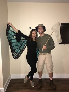 a man and woman posing with a butterfly wings costume