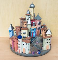 a toy castle made out of clay sitting on top of a wooden table