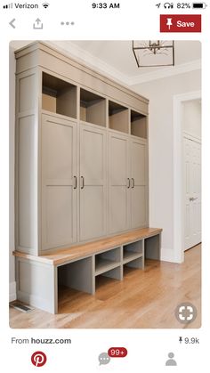 an empty room with wooden flooring and built in cabinets