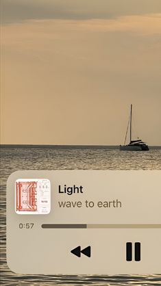 there is a sign that says light wave to earth with a boat in the background