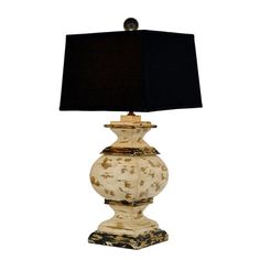 a lamp that is on top of a table with a black lampshade over it