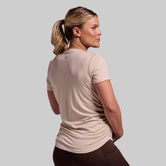 Made to be the most versatile shirt in your arsenal. We took your classic, everyday shirt and added extra stretch and a quick-drying material for all-day comfort. Finished with ruched sides that provide plenty of room for your growing belly, this is the shirt you'll reach for during every stage of your pregnancy. Beige Stretch Athleisure Top, Beige Stretch Tops For The Gym, Beige Stretch Top For The Gym, Beige Stretch Top For Gym, Beige Stretch Gym Top, Sporty Beige Workout Tops, Casual Beige Workout Tops, Everyday Stretch Beige T-shirt, Beige Stretch T-shirt For Everyday