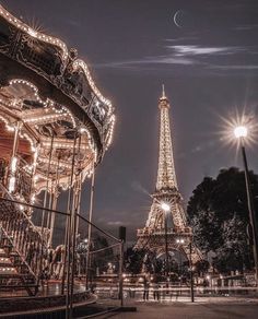 the eiffel tower is lit up at night with lights on it's sides