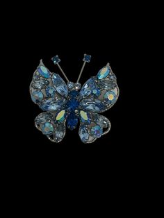 Add a touch of elegance to your outfit with this stunning Regency signed brooch. Featuring a beautiful butterfly design with light and dark blue crystal rhinestones, this vintage piece is sure to turn heads. The prong set marquise and round brilliant stones are set in silver tone metal, giving the brooch a timeless appeal. This handmade brooch is a one-of-a-kind piece and is perfect for any fashion-forward individual. The Regency brand is known for its high-quality jewelry, making this brooch a Elegant Blue Butterfly Brooches, Evening Butterfly Brooch, Butterfly Light, Butterfly Lighting, Brooch Vintage, Light And Dark, Vintage Butterfly, Brooches Handmade, Blue Rhinestones