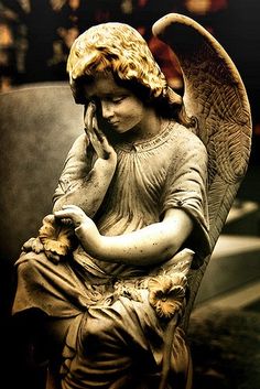 an angel statue sitting on top of a table