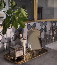 a bathroom sink with a mirror, soap dispenser and toothbrush holder