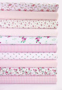 a stack of pink and white fabrics