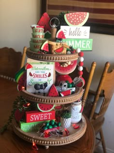 a wooden table topped with a tiered tray filled with lots of different types of items