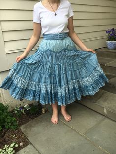 "This beautiful Suttles and Seawinds western style full skirt is designed with layered ruffles. The six layered ruffles are made from different, but complementary blue print fabrics with bias tape detail between each layer.  Gorgeous fabric and craftsmanship! The skirt length is 32\". There is an waist 28\" with an accompanying 2\" wide belt. And two side inset pockets. One of a kind!  Designed by Vicki Lynn Bardon Suttles and Seawinds- Nova Scotia. (If you are not familiar with this unique designer and shop you can look it up) Perfect to wear to any summer event or square dance!" Blue Ruffle Skirt, Vintage Jean Dress, Blue Ruffle Dress, Full Blue, Square Dance, Full Skirt Dress, 80s Dress, Prairie Dress, Ruffle Mini Dress