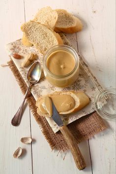 bread and peanut butter on a table with spoons