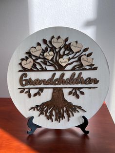 a family tree with names and hearts on it, sitting on top of a table