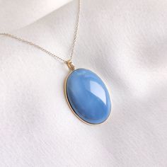 This stunning pendant is set in 14K Solid Yellow Gold with Natural Blue Opal with utmost precision. It is an unique gemstone pendant for nearly every occasion and is completely hassle-free jewelry. ITEM DETAILS * Gem: Blue Opal  * Gem Size: 21X30mm * Gem Shape: Oval  * Gem Weight: 22.91 carats * Gold Purity: 14KT  * Gold Weight: 0.63 gram * Total Weight of the Pendant: 5.19 gram The Gold purity is guaranteed and it comes with authentic 14KT gold hallmark. Since my items are handmade, they are ab Gold Opal Jewelry, Blue Opal Round Necklace, Handmade Opal Oval Pendant Necklace, Opal Pendant With Natural Stones, Polished Opal Pendant Jewelry, Blue Opal Round Pendant Jewelry, Emotional Expression, Handmade Jewelry Box, Blue Moonstone