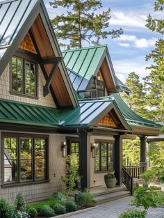 a large house with lots of windows and green roofing