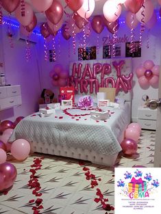 a bedroom decorated for a birthday with balloons and confetti on the bed,