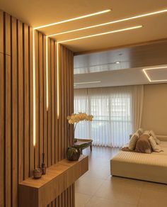 a living room filled with lots of furniture next to a tall wooden wall covered in lights