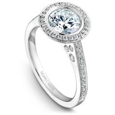 a white gold ring with an oval center surrounded by diamonds