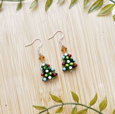 I T E M * D E S C R I P T I O N  🎄Cute mini christmas tree dangle earrings  -925 sterling silver hypoallergenic hooks  -1 inch drop length  -a perfect gift for a secret santa, coworker, or mom! ---------------------------------------------- Check out our other earrings here:  https://needfulthingsthrift.etsy.com?section_id=46781030 Check out our homepage here:  https://needfulthingsthrift.etsy.com M A T E R I A L S lampwork bead christmas trees, 925 sterling earring hooks, rubber backs for backs of earring hooks Please note, this item is handmade and may be slightly different each time it is made, But I assure that it is very close to what you see in photos All jewelry is handmade with love, designed and created by us. We are lovers of jewelry and fashion, that is why we put so much effor Santa Stocking, Handmade Jewelry Earrings, Christmas Tree Earrings, Bead Pendant, Mini Christmas Tree, Mini Christmas, Holiday Earring, Earring Tree, Holiday Jewelry