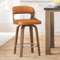 a wooden bar stool with a leather seat and back rest in front of a kitchen counter