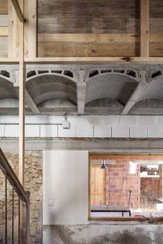 the interior of an old building with exposed beams and brick walls, as seen from another room