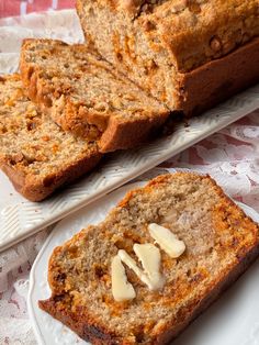 two slices of banana bread on white plates