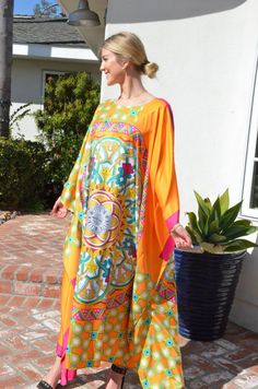 Make your day shine in this gorgeous, designer print silk caftan. Vibrant colors of orange, fuchsia and greens in a unique and special combinations of patterns with hints of gold embellishment throughout the pattern. A stunning garment for any occasion. Opaque fabric with no need of undergarment. One size. Fits medium to X-Large . Can be worn by many sizes. The width is 54 inches wide, edge to edge, or 108 inches around the body. The length is 52 inches. The side seams are 7 inches from the edge Dress Loungewear, Long Silk Dress, Silk Caftan, Beach Caftan, Silk Kaftan, Silk Dress Long, Gold Embellishment, Tent Dress, Tunic Length