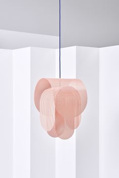 a pink light hanging from a ceiling in a room with white walls and flooring