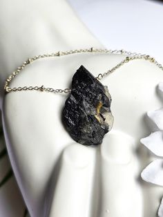 Black Tourmaline is often used as a protective stone, believed to create a shield against negative energies, psychic attacks, and electromagnetic radiation (due to its pyroelectric properties). It helps to balance and align the root chakra (connected to feelings of safety, security, and basic survival instincts). Grounding properties are thought to bring a sense of stability and connection to the Earth.  This necklace features: ~ A coated slab of Raw black tourmaline with Quartz (1.5 x.75 inches) ~ Silver plated satellite chain ~ Faceted Labradorite at the clasp ~ Silver lobster claw clasp ~ Available in 16, 18 or 19 inches.  Thanks for shopping with JewelryByOri! Shop more Tourmaline jewelry from JewelryByOri here: https://www.etsy.com/shop/JewelryByOri?ref=seller-platform-mcnav&search_qu Mystical Black Necklace For Gift, Spiritual Black Necklace With Raw Stone, Black Tourmaline Necklace With Natural Stones, Mystical Black Jewelry For Healing, Black Tourmaline Jewelry As Gift, Black Tourmaline Jewelry Gift, Spiritual Black Jewelry With Large Stone, Black Holistic Necklaces With Natural Stones, Holistic Black Necklace With Natural Stones