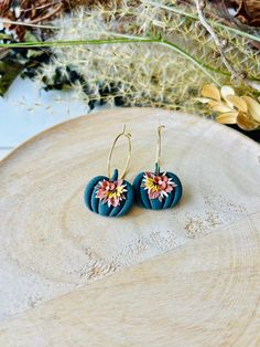 These fun pumpkin hoop earrings have been handmade with polymer clay. All floral detail work is completely done by hand giving each pair a unique look! These are truly one of a kind! You can choose from gold plated stainless steel, antiqued brass or regular stainless steel hoops. All hoops are nickel free, making these great for sensitive ears. The hoops are about 1 inch in diameter. The clay pumpkins are about 1 inch in width. The total length of the earrings is about 1.5 inches. These earrings are super lightweight and so comfortable to wear! Very cute for fall and Halloween! Be sure to check out our shop for more colors! www.etsy.com/shop/theglassbird Also come like our facebook page to receive updates on new items, coupon codes and future giveaways! https://www.facebook.com/TheGlassBir Handmade Hoop Flower Earrings For Gift, Gold Whimsical Polymer Clay Earrings, Whimsical Gold Polymer Clay Earrings, Handmade Polymer Clay Round Hoop Earrings, Handmade Small Hoop Earrings In Polymer Clay, Handmade Polymer Clay Flower Earrings In Gold, Handmade Gold Polymer Clay Flower Earrings, Whimsical Handmade Clay Earrings, Small Hoop Polymer Clay Earrings With Ear Wire