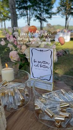 a table topped with lots of clear glass dishes filled with candles and flowers next to a sign that says, wedding ideas