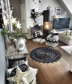 a living room filled with furniture and a fire place next to a wall mounted tv