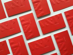 many red cards with the word love written in cursive writing on them are arranged against a white background