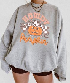 Halloween sweatshirt that will make you cozy during the spookiest time of the year! The perfect sweatshirt to cuddle up in at home, or super stylish to wear out to show your holiday spirit! PRODUCT INFORMATION * High-quality materials for the perfect cozy hoodie * Direct-to-garment printing, No cracking! * This sweatshirt runs true to size for a perfect unisex fit, please check size chart * The fabric is made from 50% cotton and 50% polyester * True to size sweatshirts, please size up for an ove Halloween Graphic Print Hoodie With Relaxed Fit, Halloween Graphic Print Relaxed Fit Hoodie, Trendy Cozy Fit Sweatshirt For Fall, Graphic Print Sweatshirt For Fall Loungewear, Spooky Long Sleeve Sweatshirt For Winter, Cozy Fit Letter Print Sweatshirt For Fall, Trendy Graphic Print Sweatshirt For Fall, Oversized Halloween Sweatshirt For Loungewear, Halloween Crew Neck Sweatshirt For Loungewear