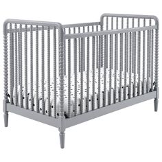 a gray crib with white bedding and wooden posts on the bottom, in front of a white background