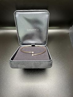 Tiffany & Co. by Elsa Peretti Diamond Hoop Single Row Rose Gold Bangle Inspired by linear beauty, the Diamond Hoop collection epitomizes modern simplicity. This sleek bangle is defined by overlapping ends accented with shimmering diamonds. Details18k Rose Gold 2 Round Brilliant Cut Diamonds TTL Diamond .10ctSize: Medium *Fits wrists up to 6.25" Tiffany Bangle, Rose Gold Bangle, Elsa Peretti, Gold Bangle, Watch Necklace, Round Brilliant Cut Diamond, Gold Bangles, Round Brilliant Cut, Ring Bracelet