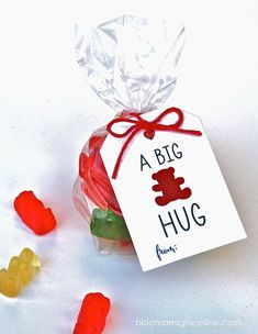 small gummy bears are in a bag with a tag that says a big hug