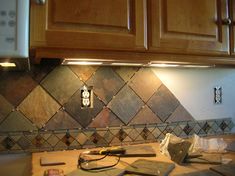 the kitchen counter is covered with tile and tools