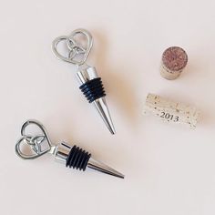 wine corks, bottle opener and corkscrew on a white surface