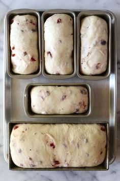 four pans filled with dough sitting on top of a counter