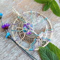 "✩ Get an instant 30% off this item by subscribing to my newsletter here http://eepurl.com/bC6Vhr Aurora Borealis Tree of Life Pendant This Aurora Borealis Tree of Life Pendant is handcrafted with sterling silver plated copper wire and permanently colored purple and blue wire. A lead and nickel free Celtic moon charm hangs hauntingly in the background with a genuine Vitrail Light Swarovski crystal set in a silver plated pewter setting. ✧Pendant is 2 inches wide and 2 inches tall not including th Handmade Purple Crafts For Crafting, Artistic Handmade Crafts As Gifts, Handmade Artistic Crafts For Gifts, Artistic Handmade Crafts For Gifts, Handmade Bohemian Crafts For Gifts, Bohemian Handmade Crafts For Gifts, Celtic Moon, Tree Of Life Pendant, Crystal Set