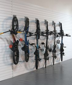 there are many bikes hanging on the wall