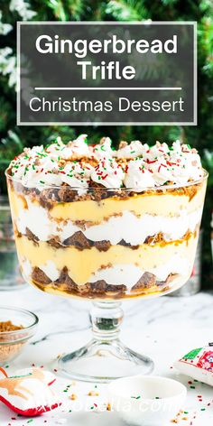 gingerbread trifle christmas dessert in a glass dish on a white table with candy canes and sprinkles