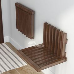 a wooden chair sitting on top of a hard wood floor next to a radiator