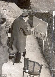 an old black and white photo of two men standing in front of a easel