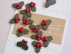 holly and berry decorated cookies on a card