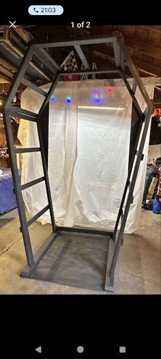 a metal frame with white fabric on it