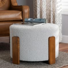 a white ottoman sitting on top of a wooden floor