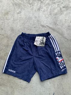 Vintage Adidas Deadstock Blue and White Sprinter Short Size M in great condition without any holes. The shorts are stretchy. Size: M (see measurements) Material: 20% Cotton, 80% Polyester Measurements: - Total length: 47 cm(18.5") - Waist: 36 cm(14.1") - Waist stretched: 50cm(19.6") NOTE: Due to the age, clothing/items can shrink or it may be that the sizing from that time the item was made in, is not the same as the sizing in modern clothing and current sizes. Make sure you check our measuremen Affordable Adidas Three Stripes Shorts, Soccer Vintage, Vintage Boxer, Shorts Adidas, Adidas Vintage, Modern Clothing, Gym Clothing, Adidas Shorts, World Of Sports